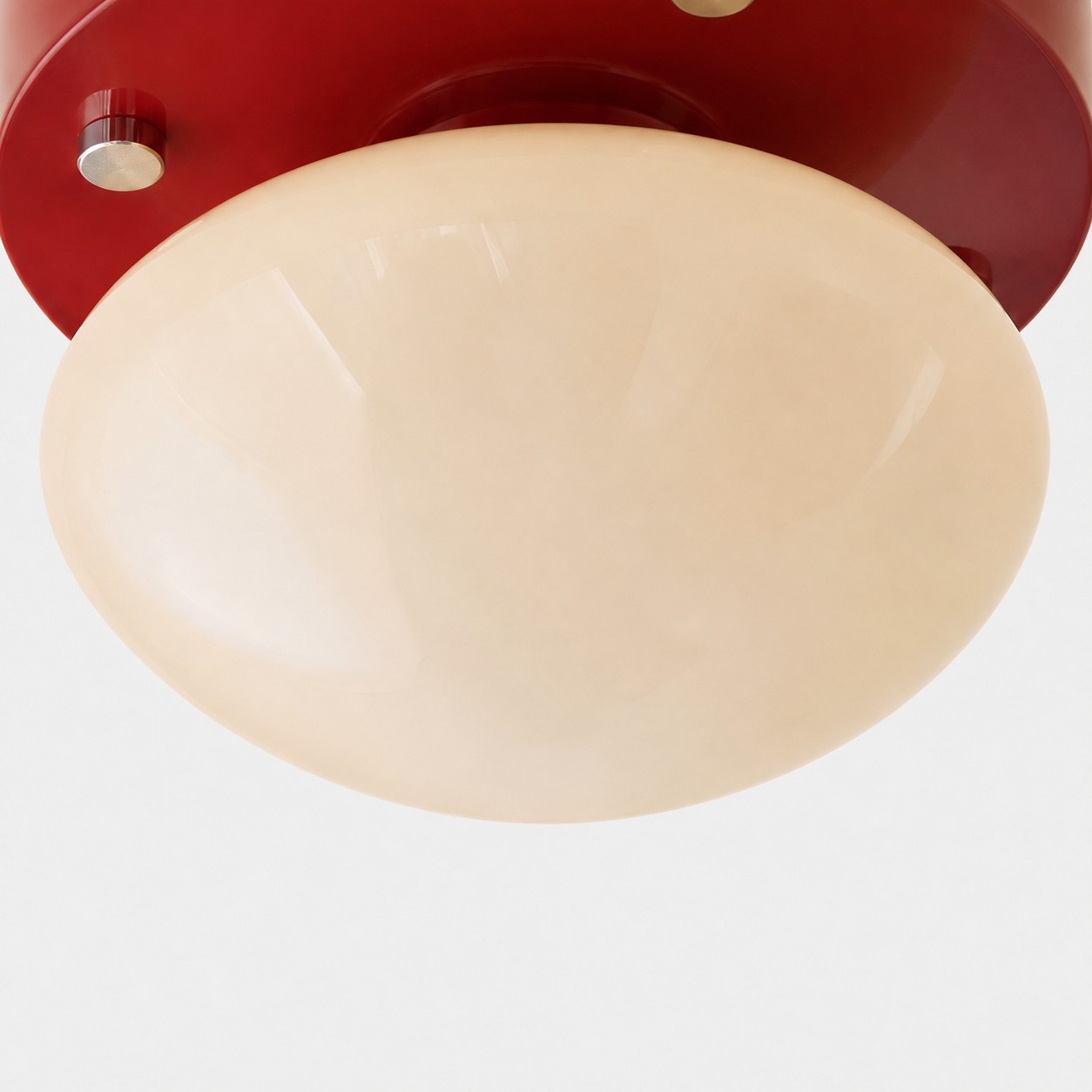 Close-up of cream glass diffuser on red LED ceiling light
