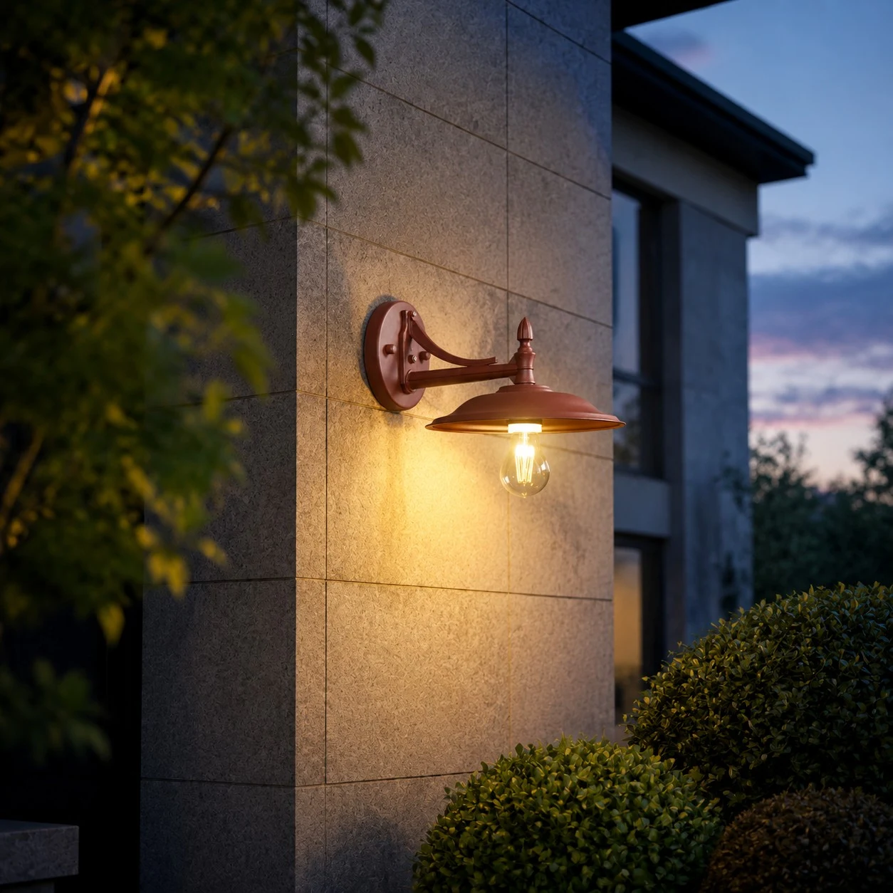 Leviaxa wall sconce glowing on an exterior wall at dusk